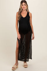 woman wearing a black maternity cover-up dress with a side slit, showing her baby bump while smiling at the camera