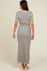 woman wearing a striped maxi dress with short sleeves, seen from the back on a neutral background