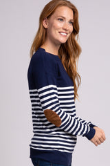 smiling woman wearing a navy and white striped sweater with brown suede elbow patches