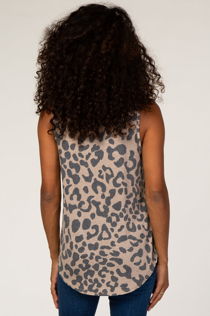 Back view of a woman with curly hair wearing a tan and grey leopard print tank top and blue jeans
