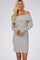 woman wearing a light gray off-the-shoulder ribbed sweater dress
