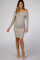 woman wearing a grey off-the-shoulder ribbed maternity dress showcasing her baby bump