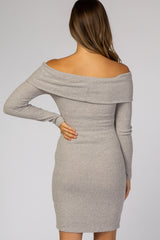 woman wearing a grey off-the-shoulder knitted maternity dress with a fitted silhouette, showing her back