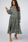 woman wearing a sage green floral long sleeve pleated maternity midi dress with beige heels