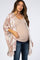 woman wearing a light pink patterned maternity kimono over a beige tank top and jeans, showcasing her baby bump