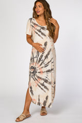 Pregnant woman wearing a tie-dye maternity maxi dress with short sleeves and side slits