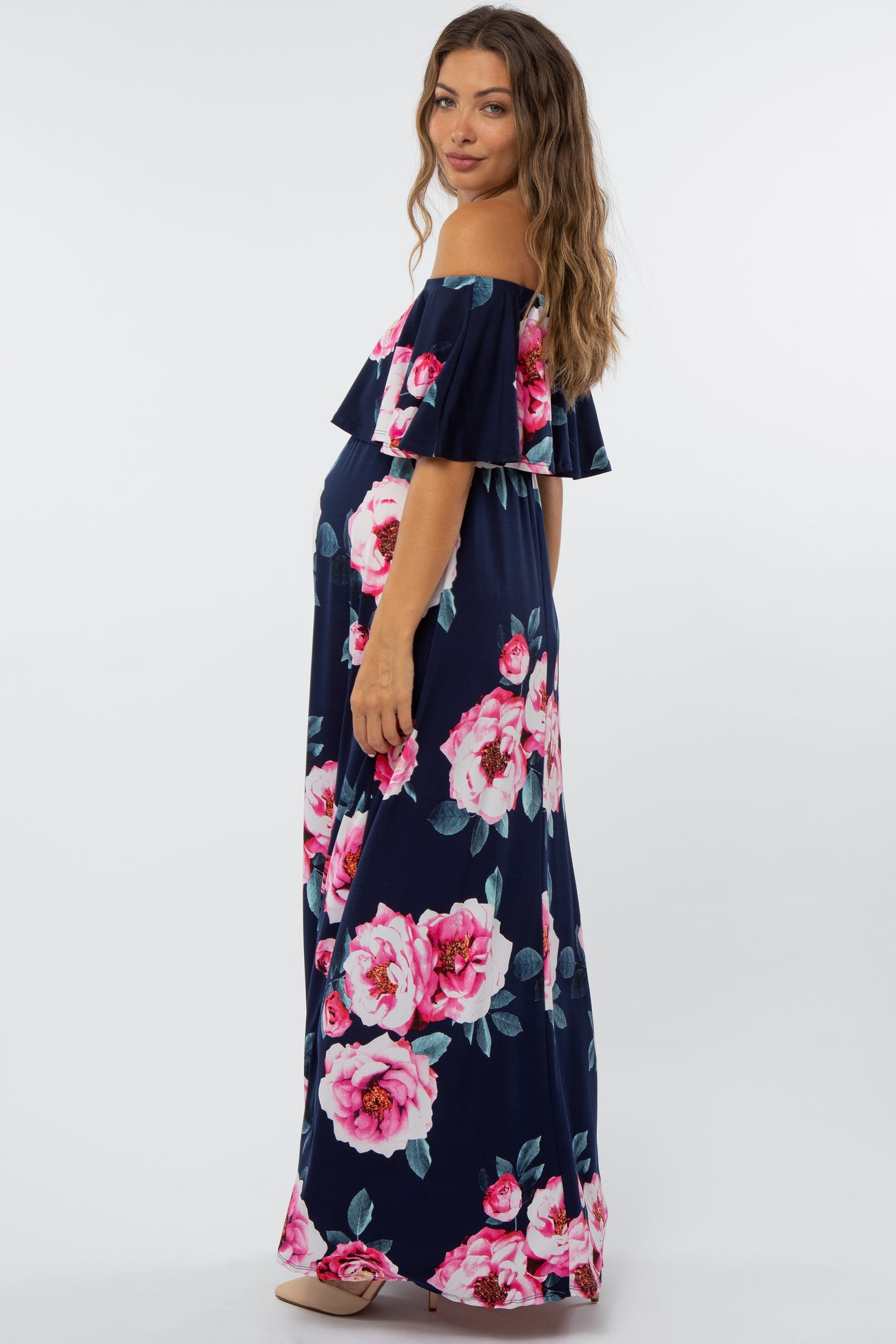 pregnant woman in navy blue floral off-the-shoulder maternity maxi dress with pink roses