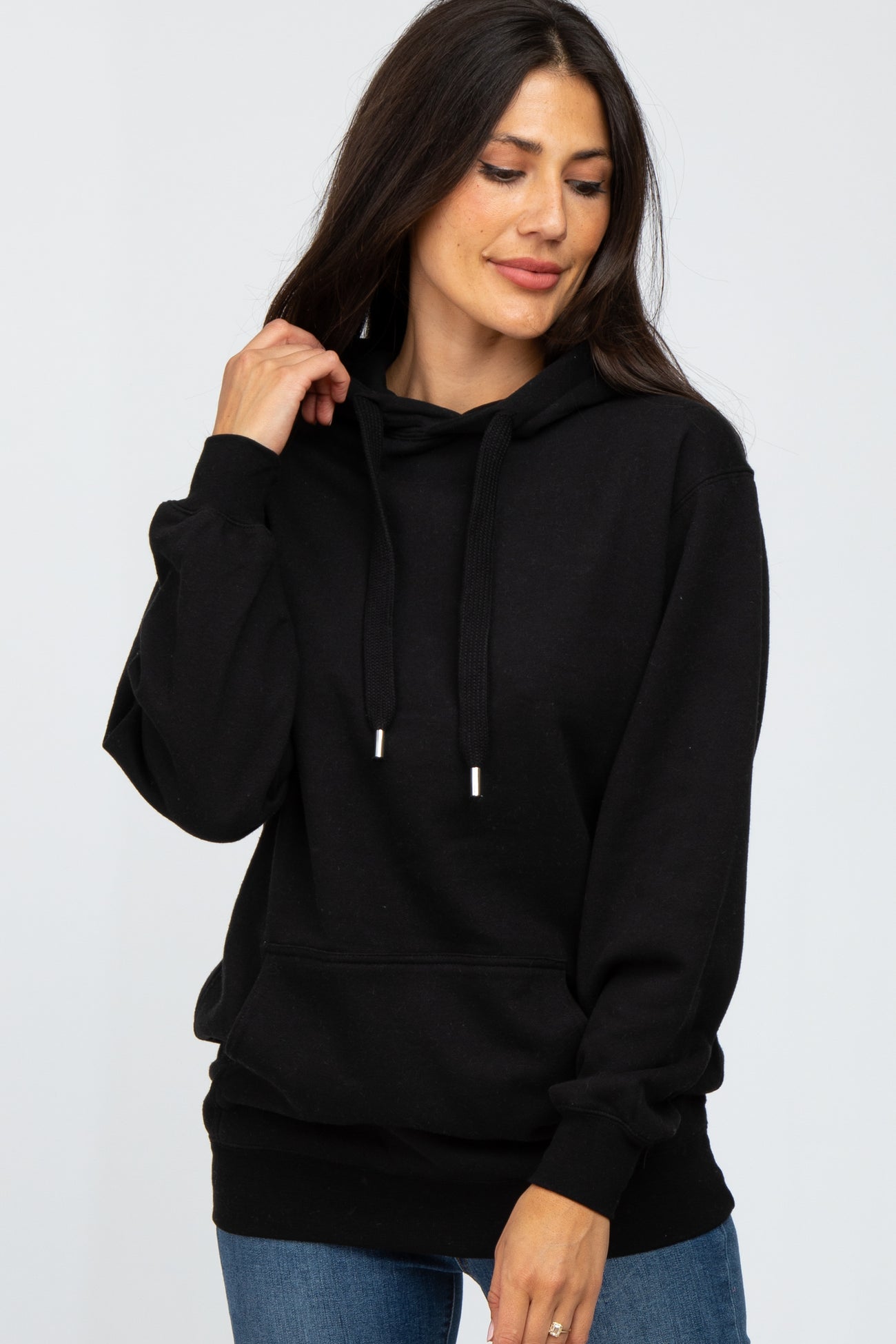 woman wearing a black long sleeve hoodie with drawstrings and a front pocket