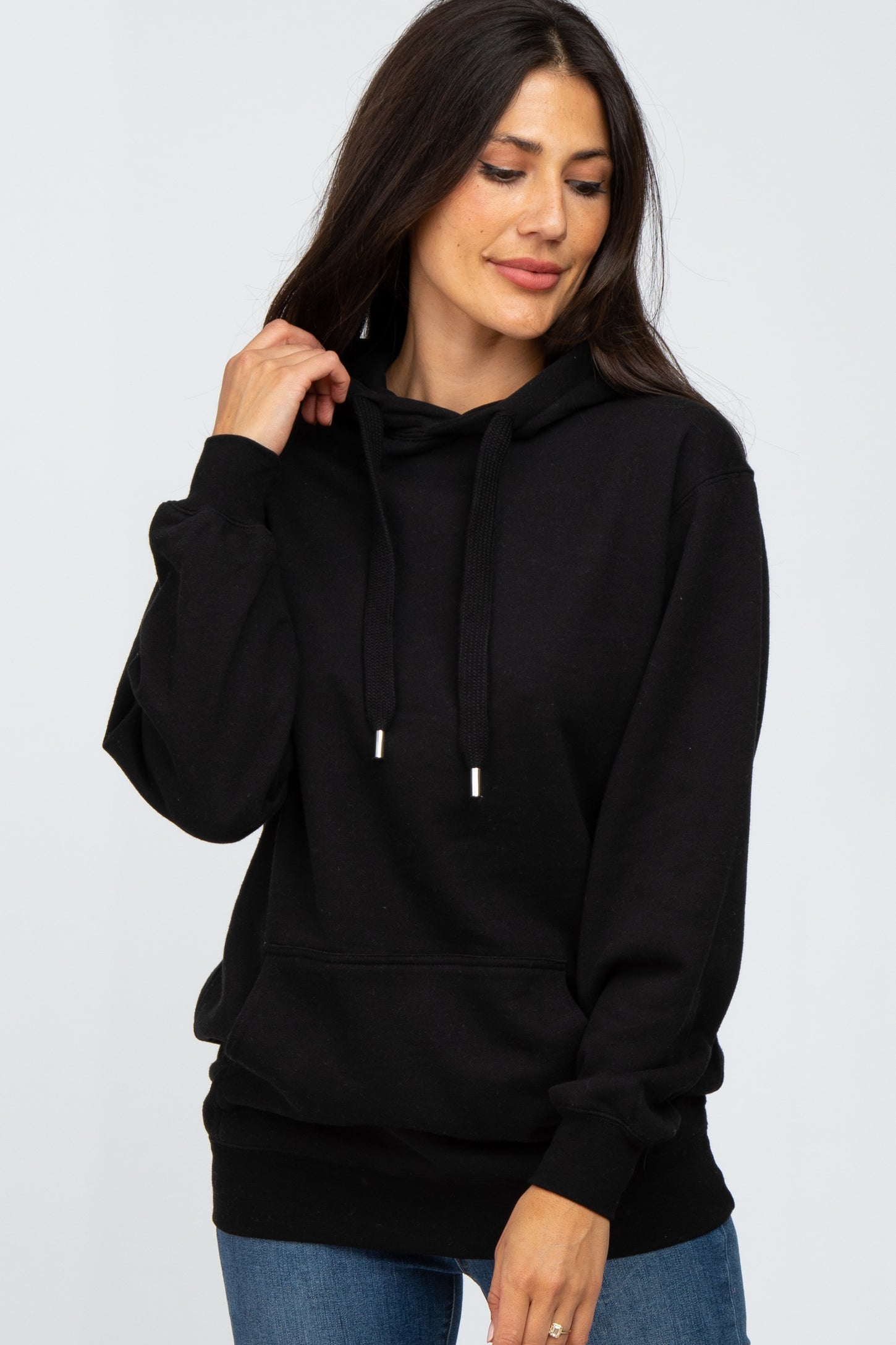 woman wearing a black long sleeve hoodie with drawstrings and a front pocket