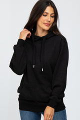 woman wearing a black long sleeve hoodie with drawstrings and a front pocket
