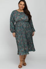 Plus size woman wearing a long sleeve teal floral pleated midi dress with brown sandals