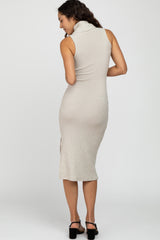 woman wearing a sleeveless beige ribbed turtleneck midi dress with black block heel sandals