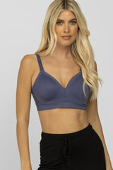 blonde woman wearing a blue wireless nursing bra and black lounge pants