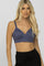 blonde woman wearing a blue wireless nursing bra and black lounge pants