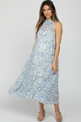 woman wearing a floral patterned maternity maxi dress with a high neckline and flowy tiers