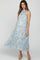 woman wearing a floral patterned maternity maxi dress with a high neckline and flowy tiers