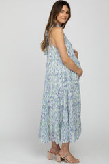 pregnant woman in a blue and purple floral tiered maternity maxi dress and tan block heels