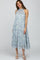woman wearing a blue and green floral tiered halter midi dress with white sandals