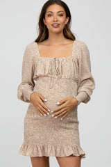 woman wearing a beige square neck maternity dress with floral print and ruffles, showcasing her baby bump