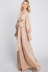 woman wearing a long beige striped maxi dress with a wrap style and puff sleeves