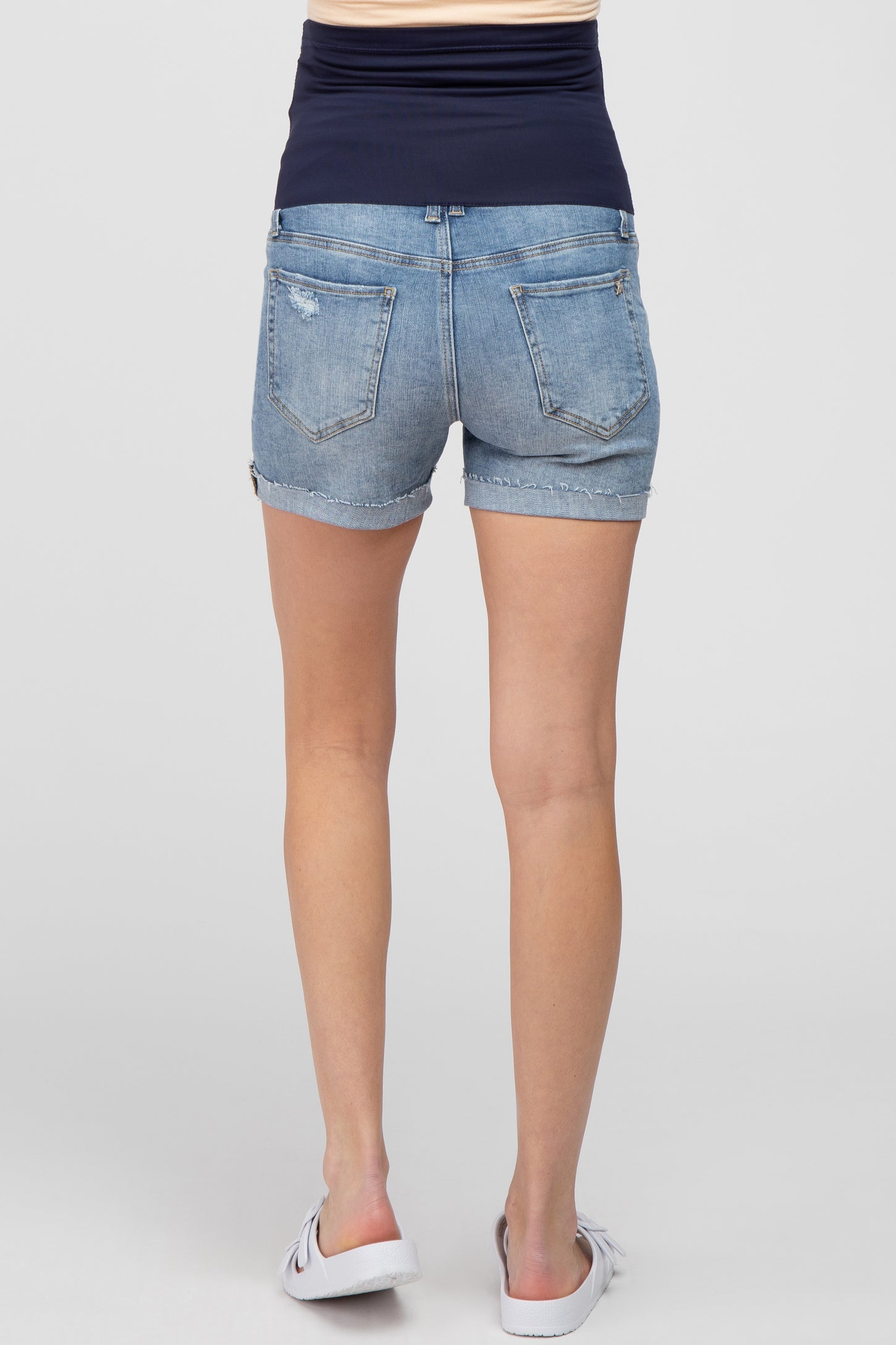 back view of maternity denim shorts with elastic belly band and cuffed hems