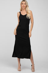 blonde woman wearing a sleeveless black midi dress with side slits and beige heels