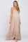 pregnant woman wearing a beige smocked halter maternity maxi dress with ruffle hem and white heels