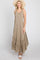 woman wearing a taupe sleeveless tiered maxi dress and straw sun hat against a white background