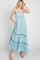 Woman wearing a light blue floral maxi dress with tiered skirt and crochet lace trim details