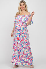 Pregnant woman wearing a floral off-the-shoulder maternity maxi dress with pink and blue flowers