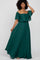 woman with curly hair wearing an off-the-shoulder emerald green maxi dress with a ruffled neckline
