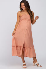 pregnant woman in peach button down maternity midi dress with ruffle trim and white block heel sandals