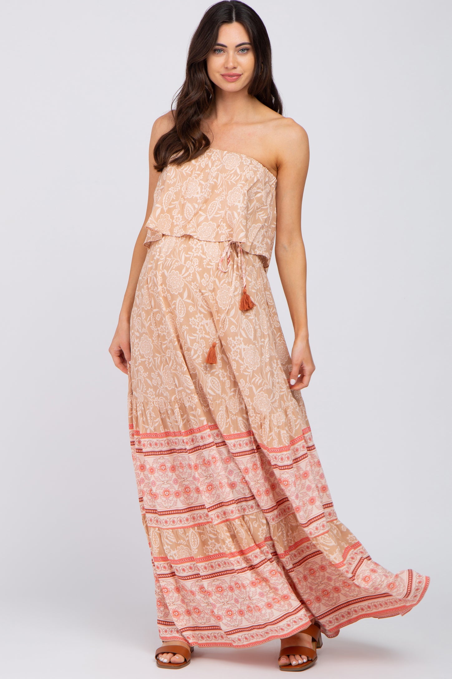 woman wearing a strapless floral maternity maxi dress with tassel drawstring and tiered skirt