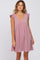 woman wearing a mauve ruffle sleeve v-neck maternity dress against a white background