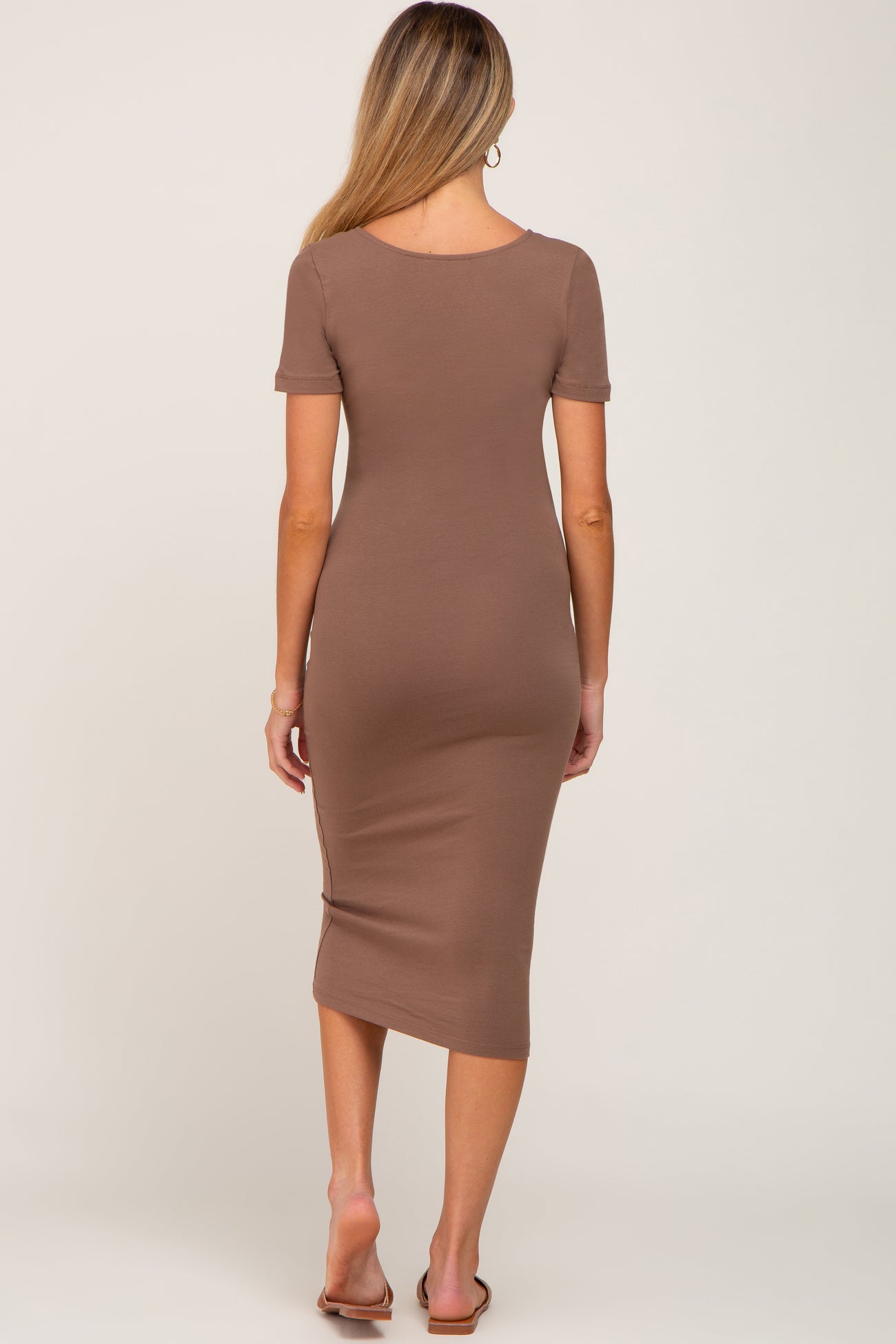 Back view of a woman wearing a short sleeve brown midi bodycon dress