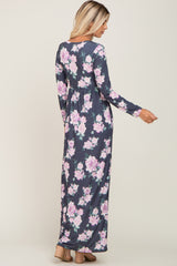 woman wearing a long sleeve navy blue floral maxi dress with pink and purple flowers