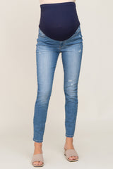 distressed light wash maternity skinny jeans with a navy blue over-the-belly support band