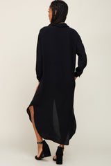 Woman from behind wearing a long black button down shirt dress and black block heel sandals