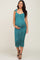 woman wearing a teal floral maternity dress with adjustable straps and a fitted silhouette, showcasing her baby bump