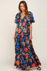 woman wearing a black floral print maxi dress with short flutter sleeves and a v-neckline
