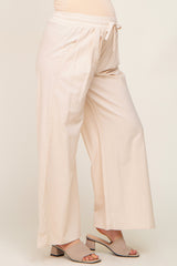 woman wearing beige wide leg maternity pants with drawstring waist and matching block heel sandals