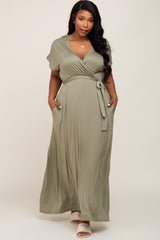 plus size woman wearing a sage green short sleeve wrap maxi dress with pockets and a tie waist