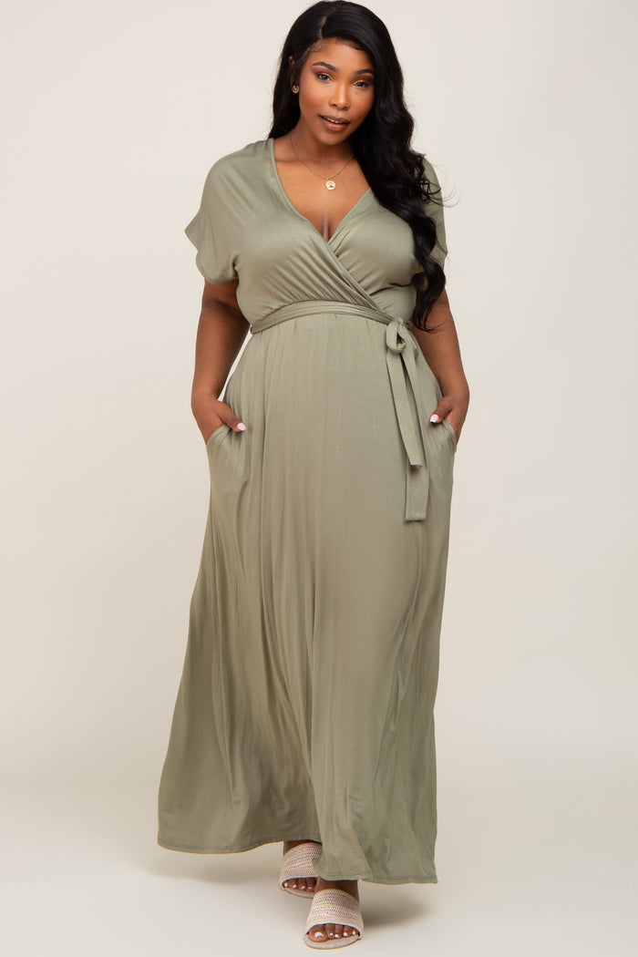 plus size woman wearing a sage green short sleeve wrap maxi dress with pockets and a tie waist