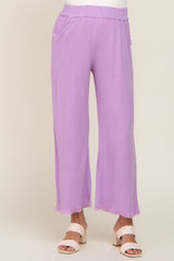 woman wearing lavender wide leg pants with frayed hem and elastic waistband paired with cream woven heels