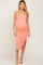 woman wearing a peach ribbed midi maternity dress with adjustable straps and side slit, showcasing her baby bump