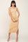 woman wearing a nude ribbed midi dress with adjustable straps and a side slit