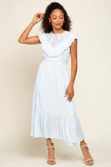 woman wearing a light blue midi dress with lace bodice and ruffle details standing against a neutral background