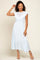woman wearing a light blue midi dress with lace bodice and ruffle details standing against a neutral background