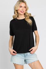 woman wearing a black short sleeve crew neck t-shirt and light wash denim shorts