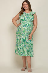 Woman wearing a green and white paisley tiered midi dress with ruffle sleeves and tan slide sandals